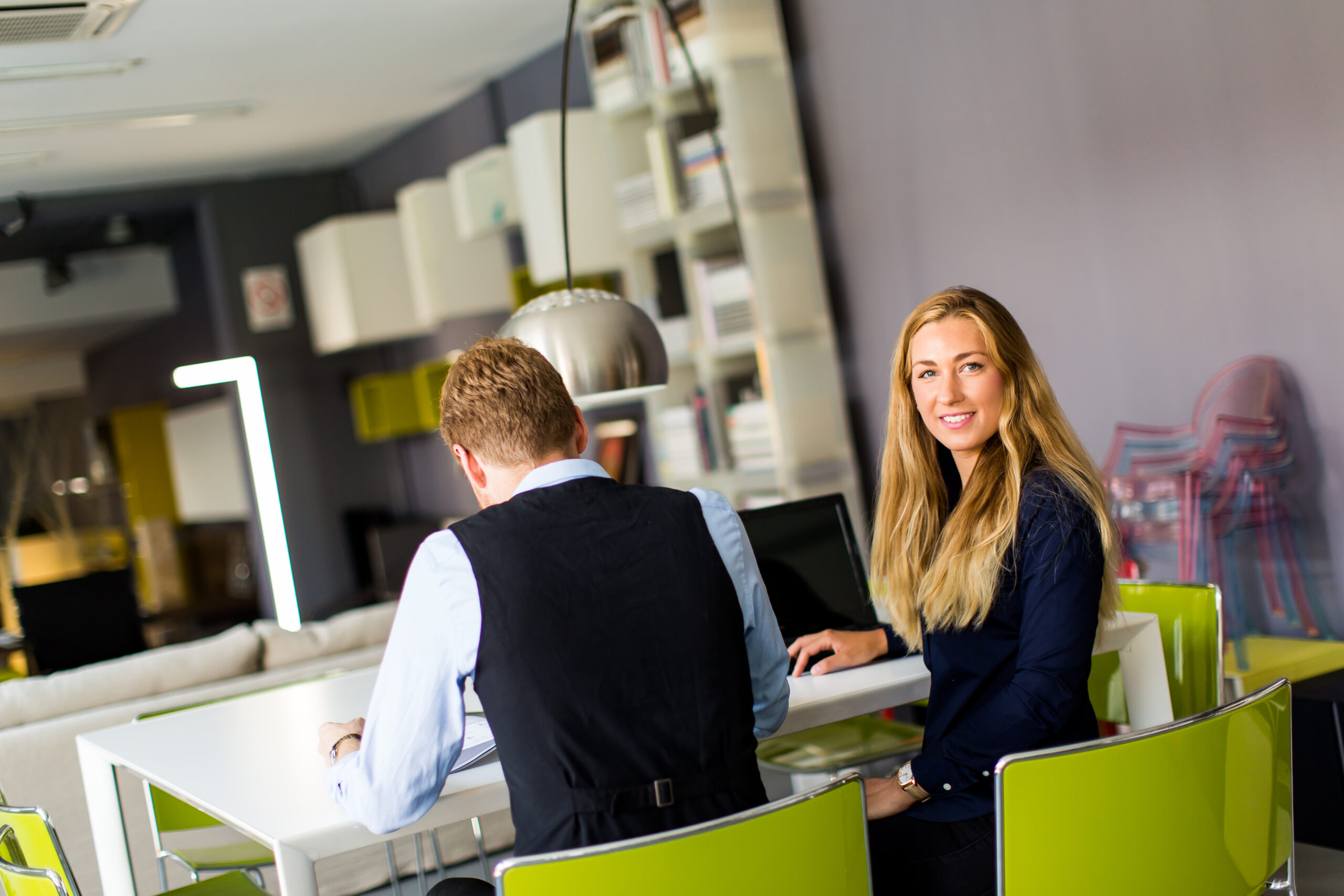Young businness people in the office Young business people sitting in the office and working together