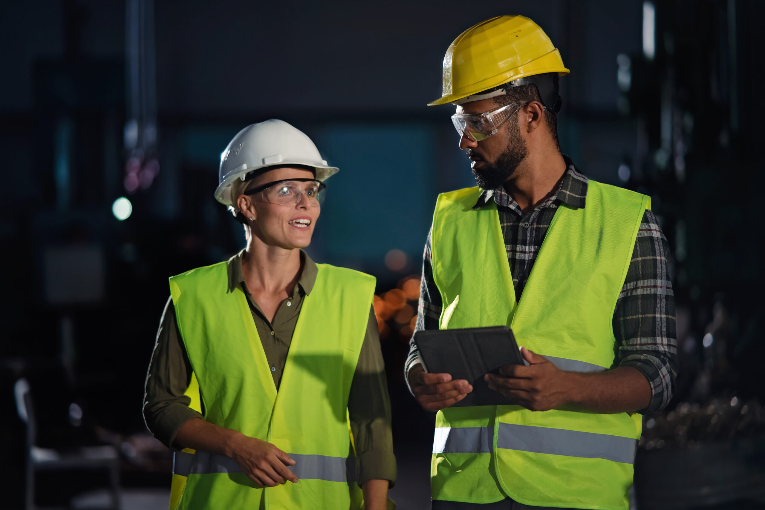 Portrait of industrial inspectors doing a general check up indoors at metal workshop. A portrait of industrial inspectors doing a general check up indoors at metal workshop.